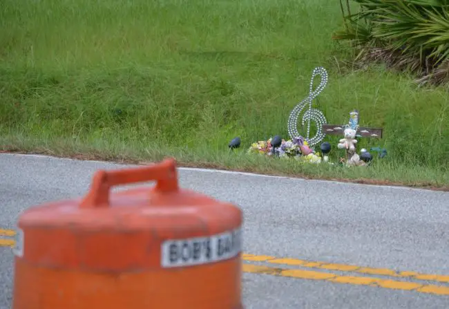 Michelle Taylor's memorial on Lakeview Boulevard in Palm Coast, opposite the construction site where a path will be built, a year and a half after she was killed by a passing car on the dark road. (© FlaglerLive)