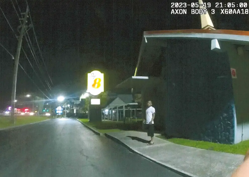 Virgilio Aguilar Mendez was standing near the sign of the Super 8 motel, where he was staying, when a sheriff's deputy found his presence there suspicious last May. (Still from body cam)