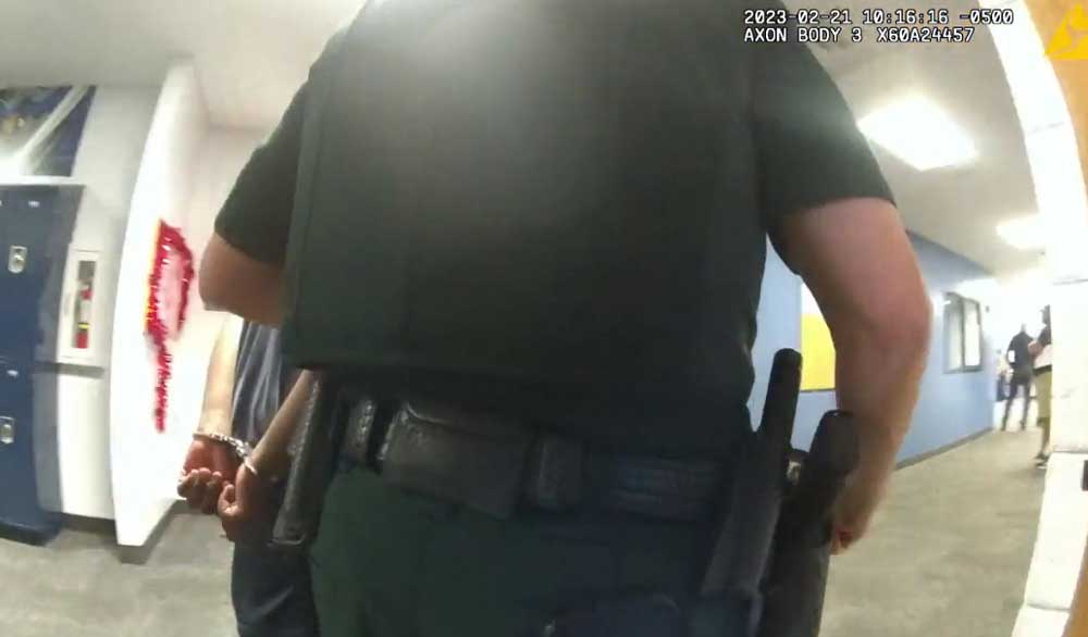 The student as he was being escorted out of the school by a Flagler County Sheriff's deputy Tuesday morning, in a still from a body camera. 