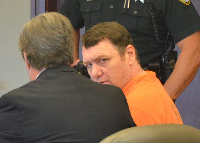 Michael Bowling looking from behind his attorney, Assistant Public Defender Bill Bookhammer, immediately after he was sentenced to 20 years in prison this morning in Circuit Court. (© FlaglerLive)