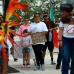 People participate in an immigration rally in Homestead, Fla., in June 2023.