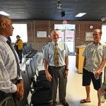 Mike Abels, center, speaking with Flagler Beach residents before the city commission meeting Thursday, with the Commission's Ken Bryan, left. (© FlaglerLive)