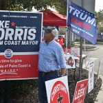 Mike Norris at the Palm Coast Community Center was pulling up stakes on his signs late this afternoon. (© FlaglerLive)