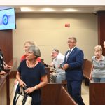 Palm Coast Mayor Mike Norris walking into court among supporters last week. Less than an hour later, he would walk out in defeat. (© FlaglerLive)