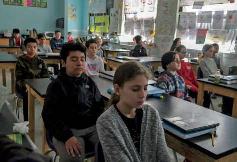 Sixth grade students start their science class with five minutes of meditation at George Washington Middle School in Alexandria, Va.
