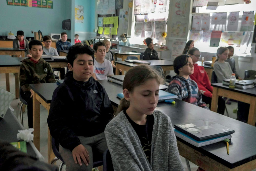 Sixth grade students start their science class with five minutes of meditation at George Washington Middle School in Alexandria, Va.