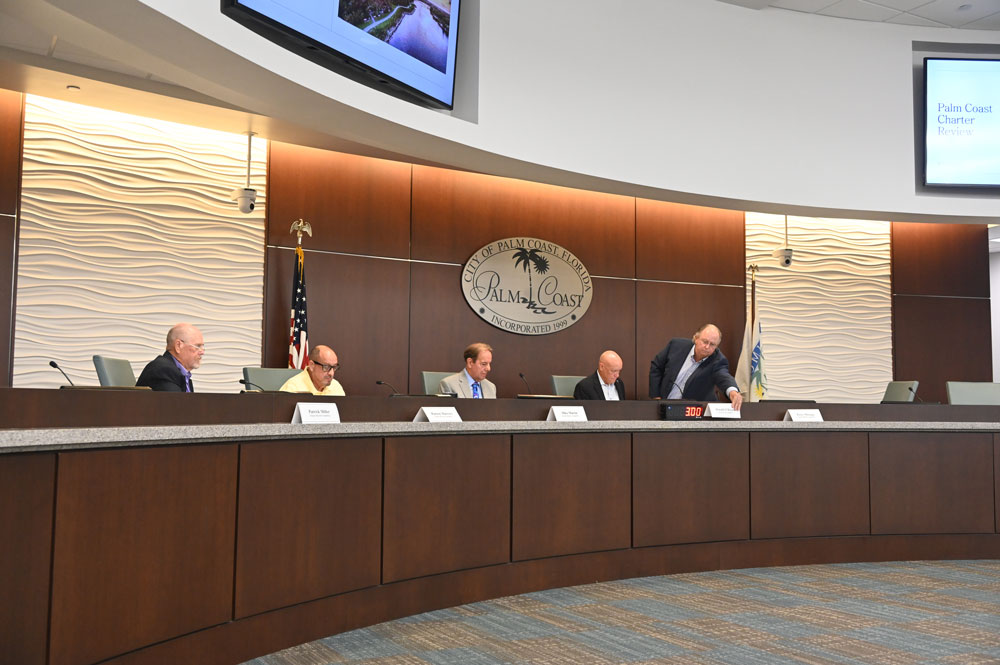From left, Patrick Miller, Ramon Marrero, Michael Martin, Donald O'Brien, and Perry Mitrano, setting O'Brien's name in front of him after O'Brien was named chair. (© FlaglerLive)