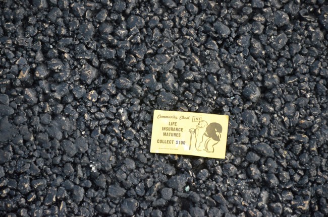 The pavement was strewn with Monopoly cards and money. Click on the image for larger view. (© FlaglerLive)