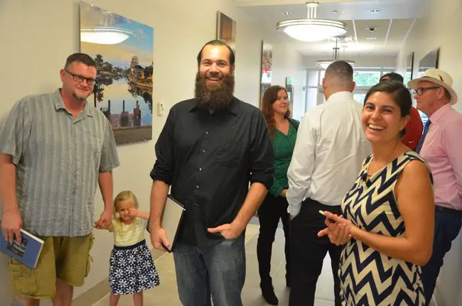 The Moonrise Brewing Company Crew after it won the unanimous approval of the Palm Coast Planning Board Wednesday. From left, Brewmaster Vance Tyson Joy and his nearly 3-year-old daughter Leia, parnters Benjamin Davenport and Ashley Dees (in the background), and, toward the right, European Village business owner Laura Castro, who is leasing the three units where the brewing company will operate. 'I’m planning on brewing the best beer of my life for this company,' Joy says. (© FlaglerLive)