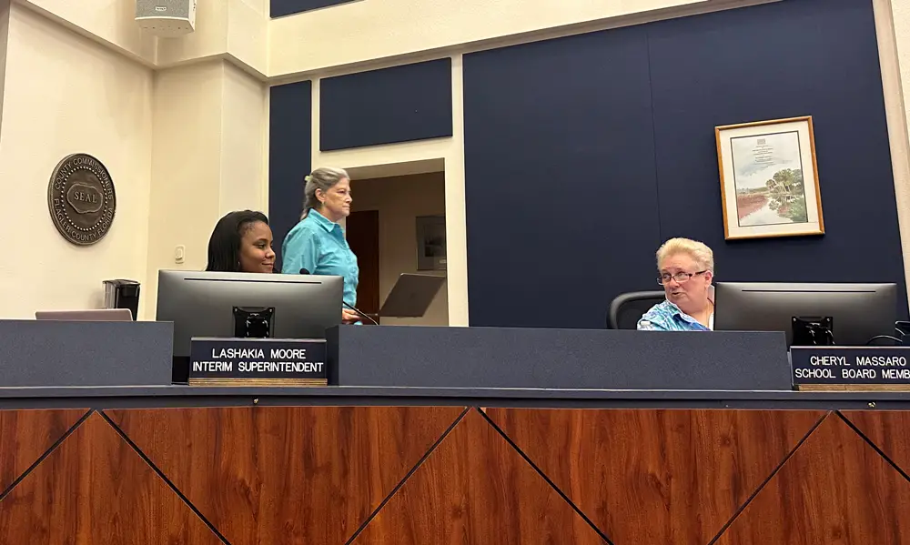 Board Chair Cheryl Massaro congratulates Superintendent LaShakia Moore on her appointment, though the occasion was marred somewhat when Board Attorney Kristy Gavin's future was put in question by Board member Sally Hunt. (© FlaglerLive)