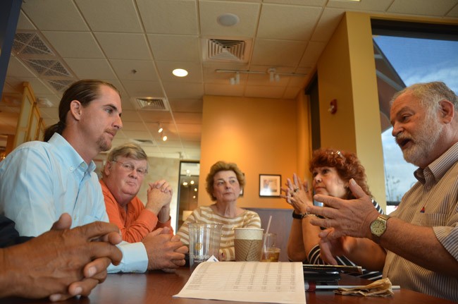 Democratic candidate Adam Morley, left, facing the Democratic Progressive Caucus's Merrill Shapiro in a get-acquainted meeting Monday at Panera Bread ion Palm Coast. Others at the table, from left, included Wayne Wright, Carol Wright and Aynne McAvoy. (© FlaglerLive) 