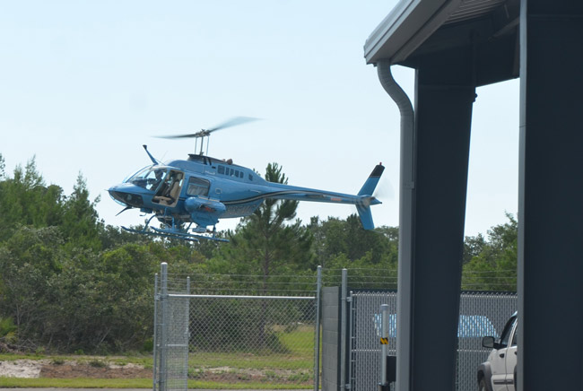 East Flagler Mosquito Control's12-year-old helicopter coming in for a landing at the district's new facility at the south end of the Flagler County Executive Airport. (© FlaglerLive)