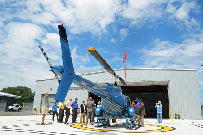 Mosquito Control Pilot Kevin Card this morning gave visitors a brief overview of his duties at the end of a tour of the East Mosquito Control District's new facilities at the Flagler County Executive Airport. (© FlaglerLive)