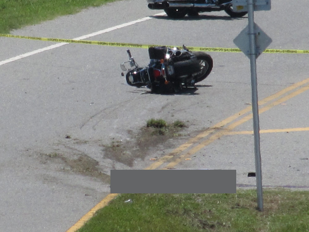 The crash scene on State Road A1A on Thursday afternoon. The victim--blocked out--remained at the scene until the medical examiner claimed the body in mid-afternoon. (© Bob Ziolkowski for FlaglerLive)
