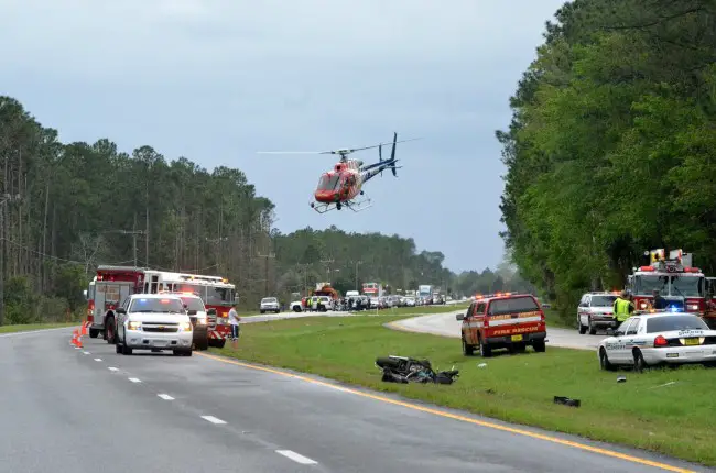 Flagler County Fire Rescue's Fire Flight helicopter takes off just before 4 p.m. on U.S. 1, south of Bunnell, with two of the three victims in a motorcycle-and-Cadillac wreck on the highway. Click on the image for larger view. (c FlaglerLive)