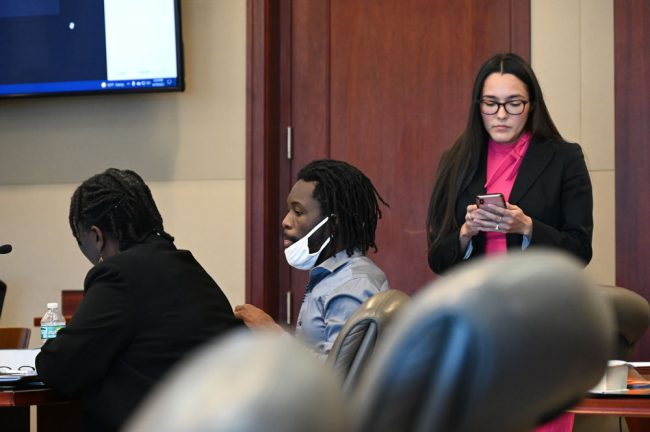 Kwentel Moultrie, center, and Assistant Public Defender Alexis Nava-Martinez, standing, who presented opening arguments in his defense. (© FlaglerLive)