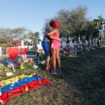 Two mourners embrace at a memorial for those killed in the Parkland, Florida, school shooting in 2018. (AP Photo/Gerald Herbert)