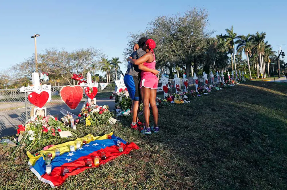 Two mourners embrace at a memorial for those killed in the Parkland, Florida, school shooting in 2018. (AP Photo/Gerald Herbert)