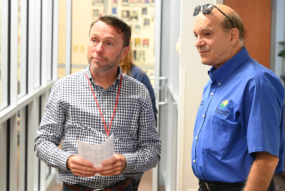Deputy County Attorney Sean Moylan, left, and County Attorney Al Hadeed last August during the primary election, when they served as counsel for the Canvassing Board. (© FlaglerLive)