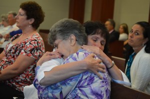 Angela Mulhall, in the foreground, Dana's 76-year-old mother, in a hug with his sister, Karen Mulhall Theriault, immediately after the verdict was announced. Click on the image for larger view. (© FlaglerLive)