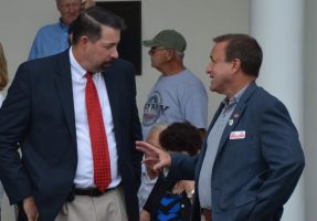 Commissioner Joe Mullins, right, in a conversation with Craig Coffey. (© FlaglerLive)