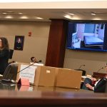 Assistant State Attorney Melissa Clark, left, showing the jury, during closing arguments, the murphy bed and the layout of the bedroom in the Palm Coast home where Monserrate Teron is accused of having sexually assaulted his 7-year-old niece in November 2019. (© FlaglerLive)