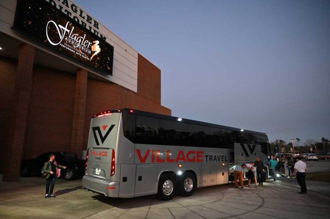 The 68 musicians arrived in a pair of buses at dusk. The second bus is behind that one. (© FlaglerLive)