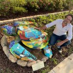 JJ Graham with Nadia, the turtle he painted for its installation at Palm Coast City Hall in 2019. (© FlaglerLive)