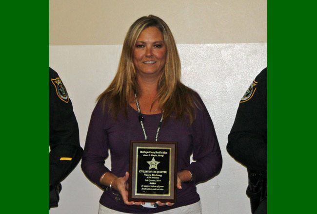 The Sheriff's Office's Nancy Birdsong with one of the internal awards she has collected over the years. (FCSO)