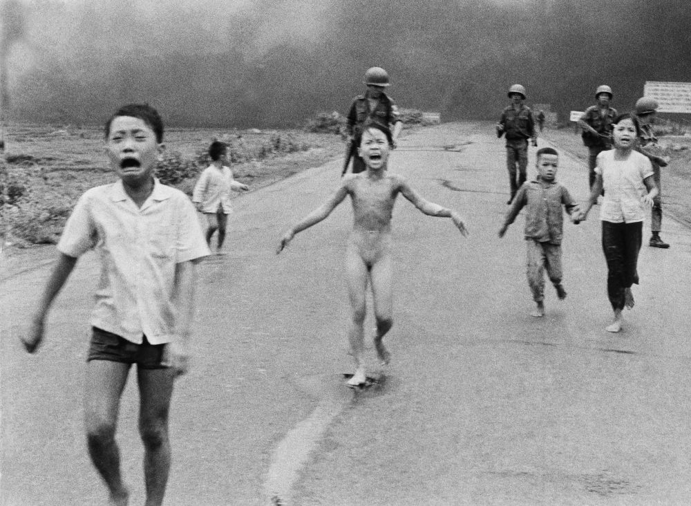 Terrified children, including 9-year-old Kim Phuc, center, near Trang Bang, Vietnam, after a South Vietnamese plane on June 8, 1972, accidentally dropped its flaming napalm on its own troops and civilians. (AP Photo/Nick Ut, File)