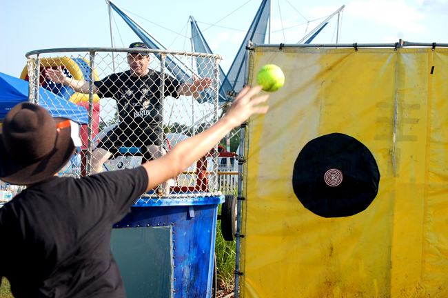 Coounty Commissioner Nate McLaughlin, being a good sport, about to get dunked at Palm Coast's recent Rock 'n Ribfest at Town Center. The pitcher is Alexander Lynn. (© FlaglerLive)