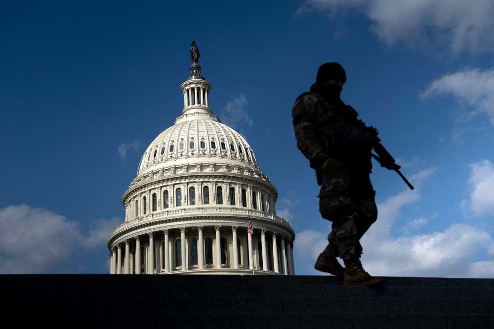 A member of the National Guard patrols the U.S. Capitol on March 4, 2021. (Brendan Smialowski/AFP via Getty Images)