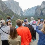 Crowds often form at popular places in U.S. national parks, like the entrance to Yosemite Valley in California.