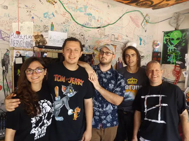 Pictured in The Ned’s recording studio and rehearsal space in Palm Coast are, from left: Marissa LiCausi of the band Flora LiCrame, The Ned drummer Joe Gardella, The Ned PR/booking manager Justyn Perry, The Ned singer-guitarist Trace George, and The Ned manager Artie “Papa Ned” Gardella. (© FlaglerLive)