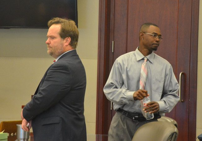 C.J. Nelson, right, moments after the verdict, looking at his family, as his attorney, Josh Davis, spoke with the judge about sentencing. (© FlaglerLive)