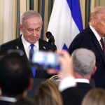 Two men in suits stand at podiums in front of flags. U.S. President Donald Trump and Israeli Prime Minister Benjamin Netanyahu arrive for a joint news conference at the White House on Sept. 29, 2025.