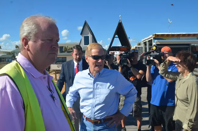 U.S. Sen. Bill Nelson, center, took a walk on the Flagler Beach pier Wednesday morning with City Manager Larry Newsom, right, and County Commission Chairman Barbara Revels. County Administrator Craig Coffey is just behind the senator. (© FlaglerLive)