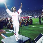 Whitney Houston sings the national anthem on January 27, 1991, at Super Bowl XXV during the Persian Gulf War. (Michael Zagaris/Getty Images)