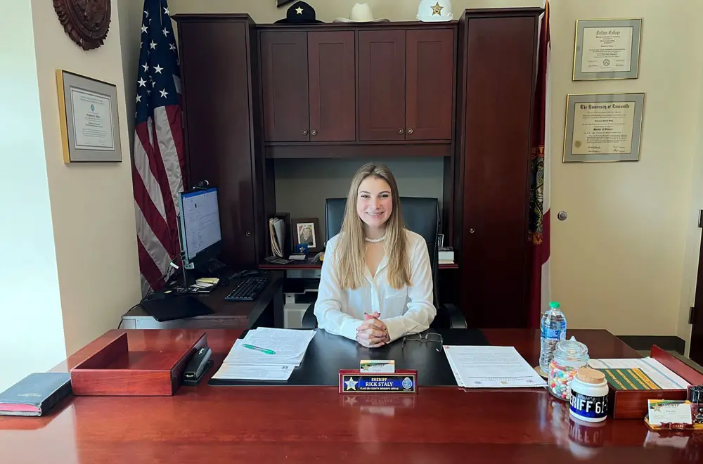 Kadance Nickmeyer, a student at Matanzas High School, at Sheriff Rick Staly's desk after winning an essay contest that meant spending the day with the sheriff. (FCSO)