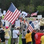 Protesters at the No Kings rally on State Road 100 in Palm Coast last October. (© FlaglerLive)