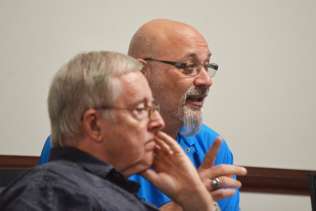 Council member Steven Nobile (his finger raised) wants council salaries to be raised to around $40,000. Bill McGuire, in the foreground, disagrees. (c FlaglerLive)