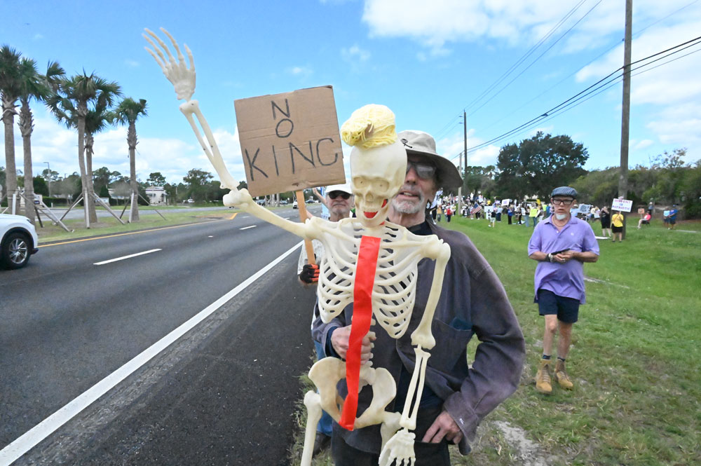 A protester on No Kings Day in palm Coast on Oct. 18. (© FlaglerLive)