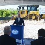 Palm Coast Mayor Mike Norris last month at the groundbreaking for the road opening the so-called "western expansion," where Norris was critical of the developer. (© FlaglerLive)