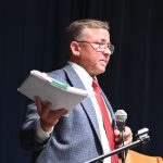 Mike Norris with a copy of the ethics complaint against him as he addressed his town hall crowd about it on Monday, saying it had been dismissed. (© FlaglerLive)