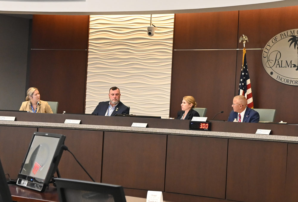 Back in December, Mike Norris would still look occasionally Acting City Manager Lauren Johnston in the eye. (© FlaglerLive)