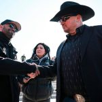 Enrique Tarrio, left, former leader of the far-right group the Proud Boys, shakes hands with Oath Keepers founder Stewart Rhodes in Washington on Feb. 21, 2025.