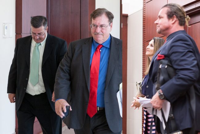 The parties arriving at this morning's hearing before Circuit Judge R. Lee Smith at the Flagler County Courthouse. From left, David O'Brien and his attorney, Stephen Alexander, Palm Coast Mayor Milissa Holland, and her attorney, Doug Kneller. (© Jon Hardison for FlaglerLive)