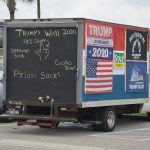 The mastodon truck now bearing much more offensive signs, when it was a bit more po9lite last November, parked at one of its favorite spots: Veterans Park in Flagler Beach. (© FlaglerLive)