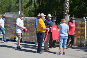 Several city and county officials gathered to volunteer at the City Hall location. Mayor Milissa Holland is to the right. Click on the image for larger view. (© FlaglerLive)