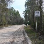 Old Brick Road at the Flagler-St. Johns County line. Flagler County has been coating the 111-year-old brick road with sand to reduce damage from logging trucks, the principal users of the public road. (© FlaglerLive)